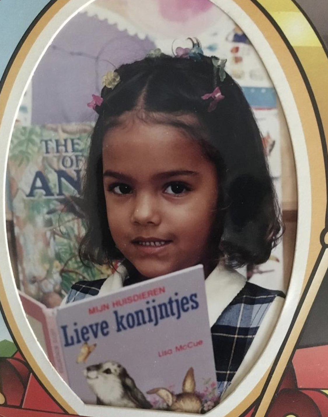 School portrait of Joline holding a picture book