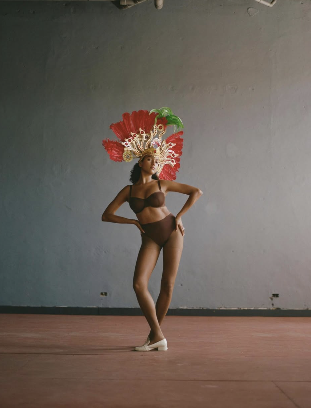 Joline in a carnival costume with a feather headdress